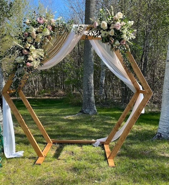 Enchanting Wedding Arch Décor With Hexagonal Arch Stand, Fabric Drapes, Flowers & Foliage 