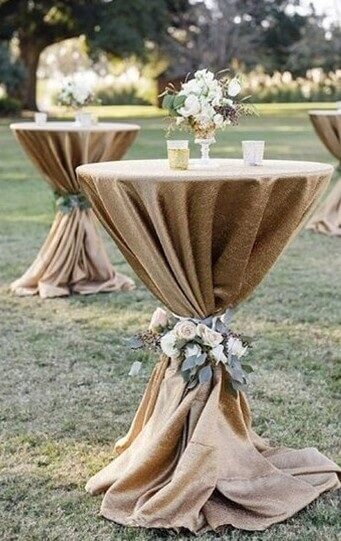 Opulent Cocktail Table Setup With Velvet Tablecloth, Candles, Flowers And Garlands