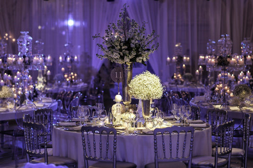 purple themed event with candle centerpieces